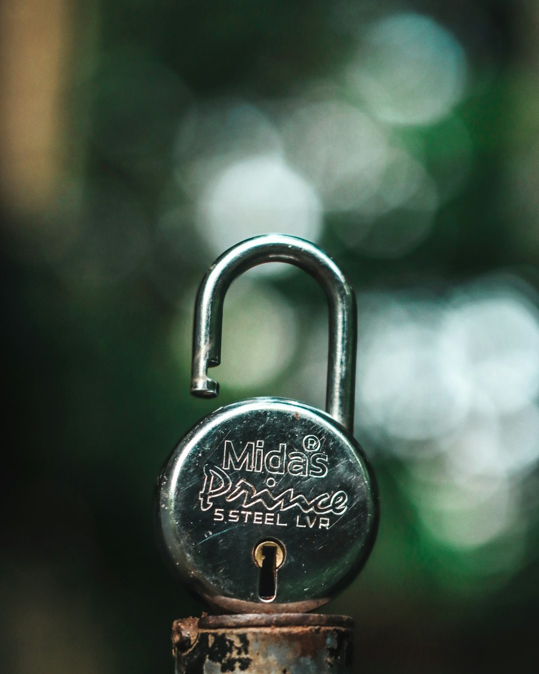Laptop screen with encrypted padlock icon in a dark room