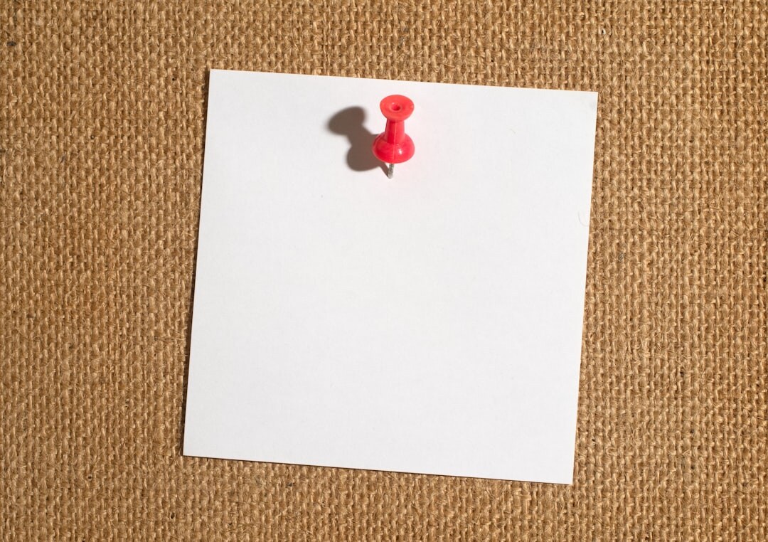 Corkboard with pinned documents and red thread connections